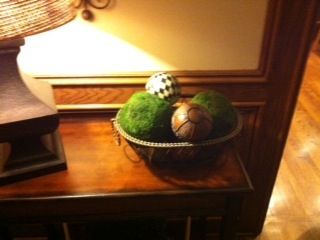 A bowl full of spheres is updated with a couple of moss covered balls.