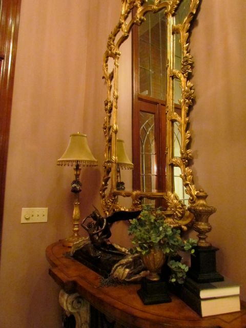 Beautiful gilded mirror in foyer.