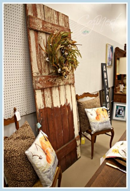 Barn door flanked by vintage chairs
